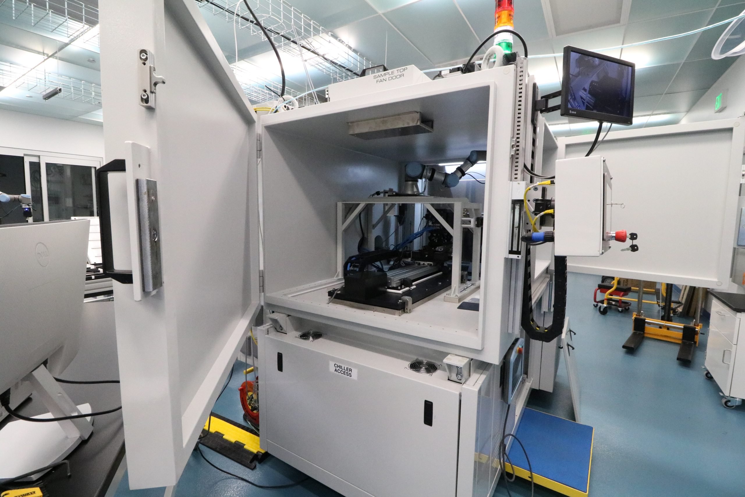 MAXIMA with door open, showing XRD, XRF, and robotic arm apparatuses.