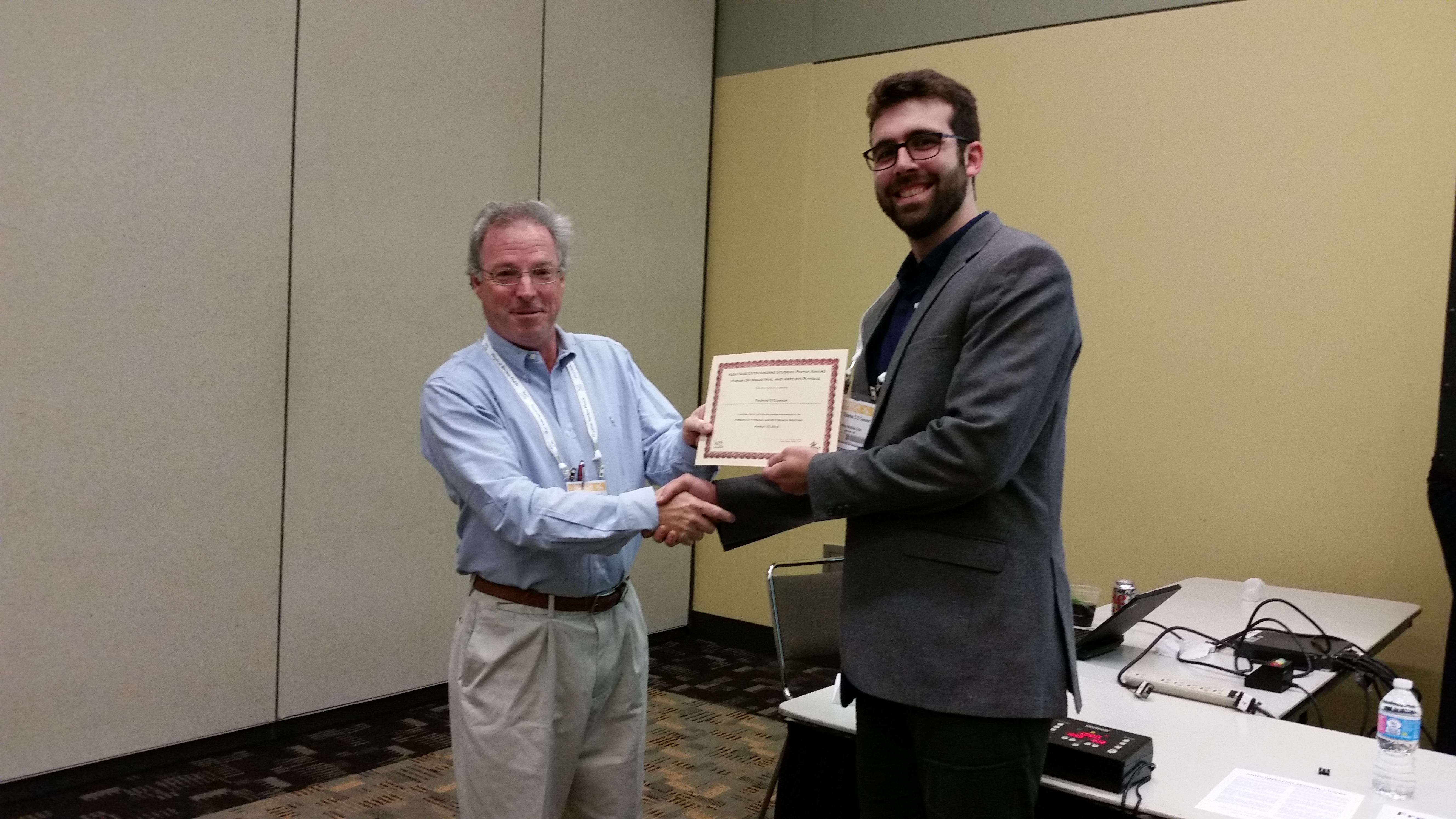 Thomas O'Connor (right) received the Ken Hass Outstanding Student Paper Award at the FIAP March meeting.