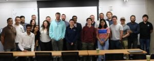 Group of individuals standing in front of classroom