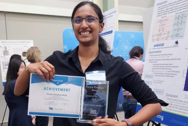 Purna Vindhya Kota smiles while holding her Intern of the Year award from Idaho National Laboratory.