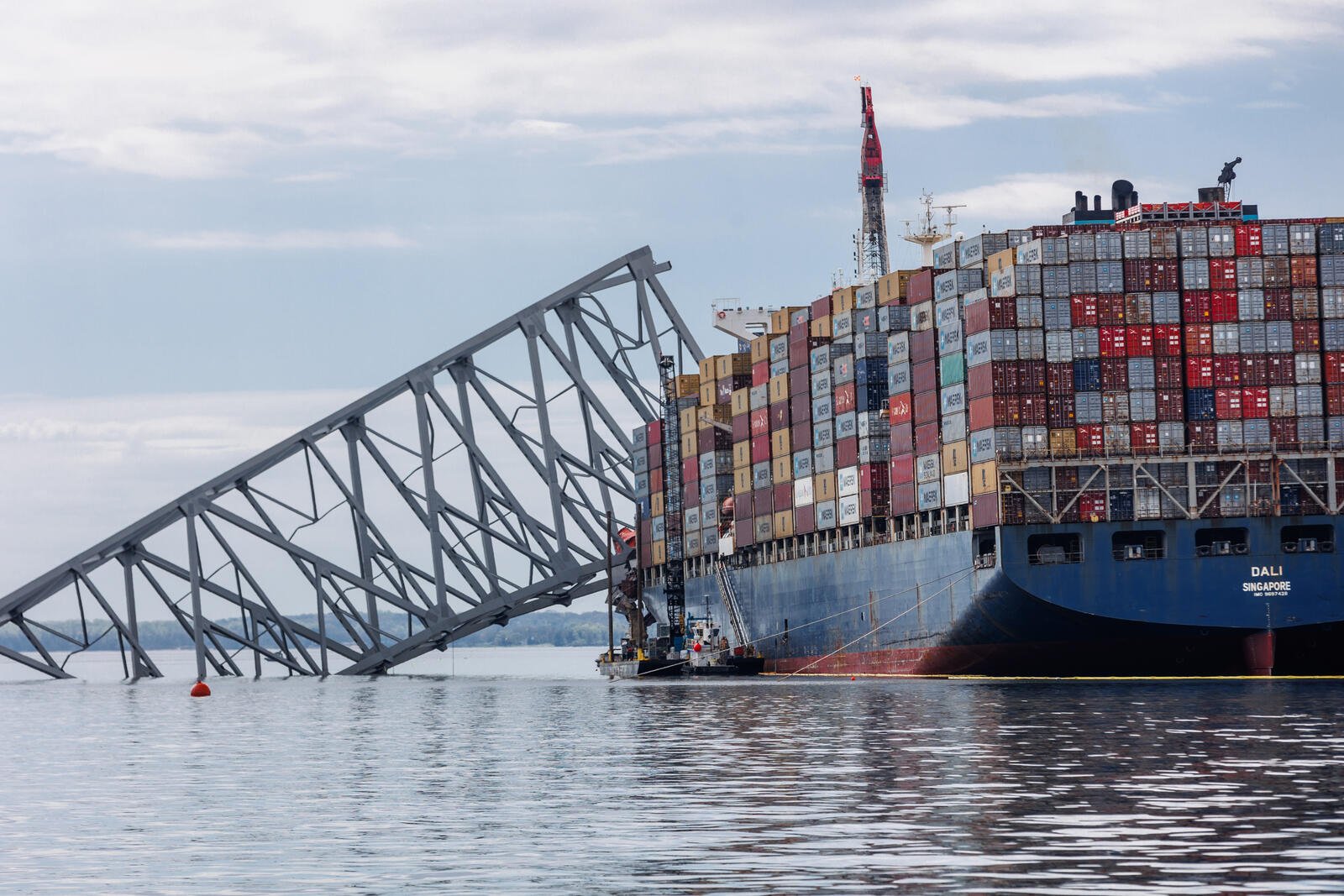A large container ship lodged in the wreckage of the Francis Scott Key Bridge in the immediate aftermath of its collapse.