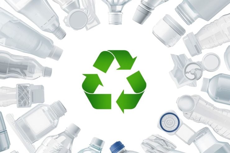 Recycling symbol surrounded by plastic bottles